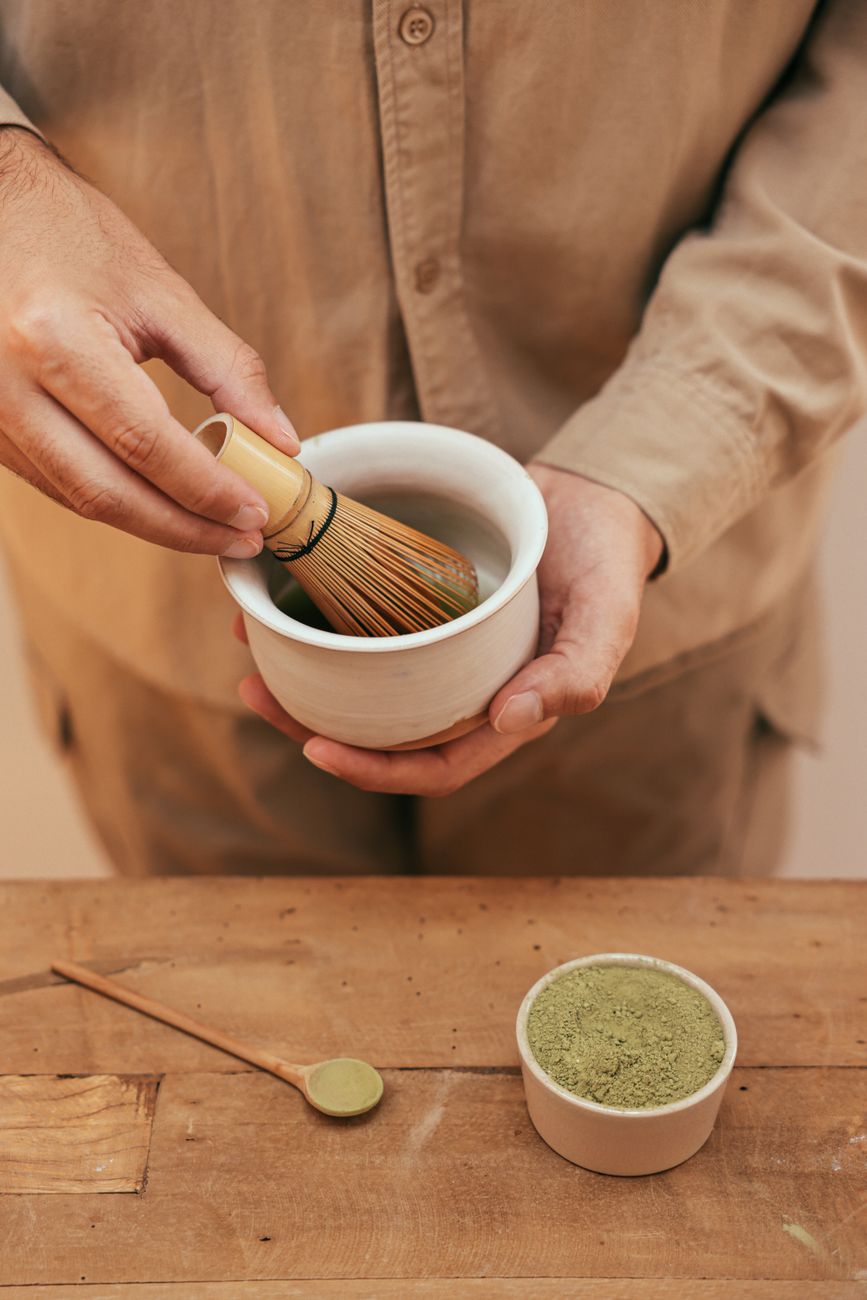 Whisking matcha inside traditional tea room